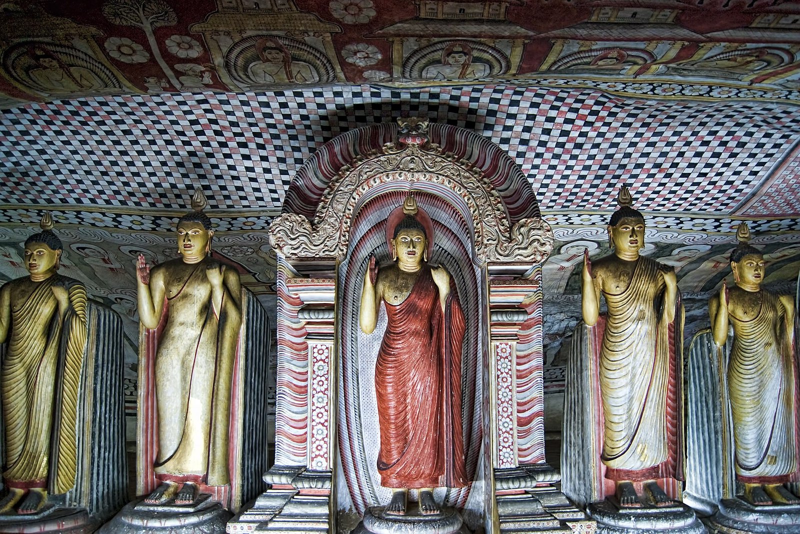 Painted ceiling and Buddha statues inside the Dambulla cave temple