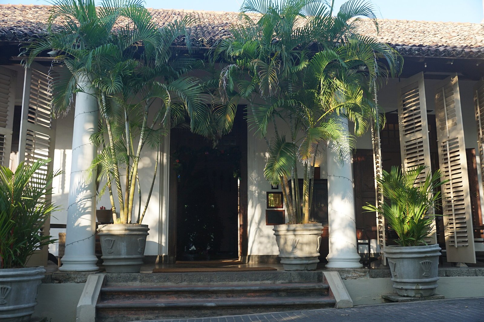 Colonial-era Galle Fort Hotel building with palms at its entrance