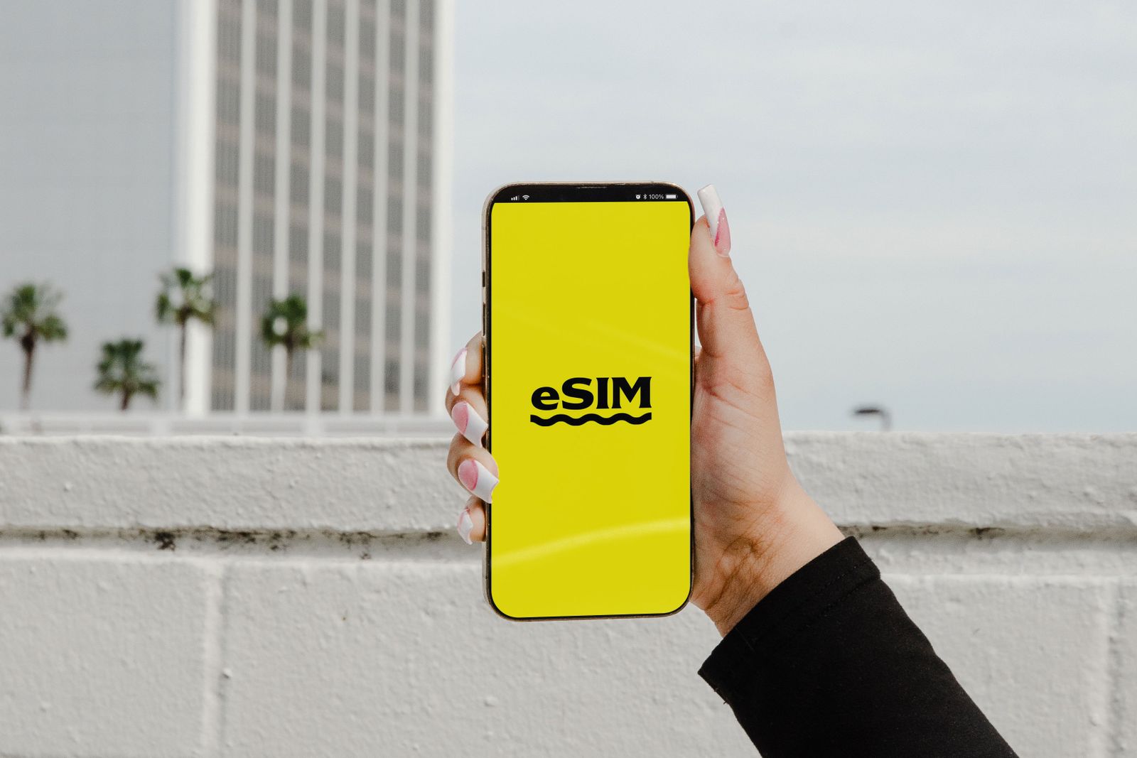 Hand holding smartphone with eSIM — eSIM option for tourists in Sri Lanka