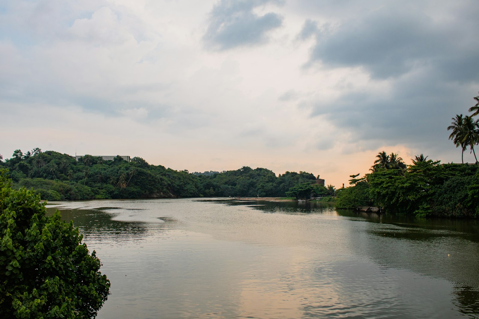 A calm lake reflects a cloudy sky.